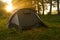 Tourist tents on riverbank at sunrise