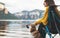 Tourist think traveler relax together dog on mountain scape,  woman hug pet rest on lake shore nature trip