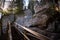 Tourist trail with wooden path walk and stairs near sandstone cliffs. river gauja in Latvia. The cliff of Sietiniezis