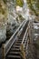 Tourist trail with wooden pathwalk and stairs near sandstone cliffs. river gauja in Latvia. The cliff of Sietiniezis