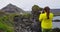 Tourist on travel taking photo with DSLR Camera, Iceland Arnarstapi Snaefellsnes