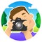 Tourist, traveler, blogger; smiling guy with a camera on the nature, on a picnic, in the park; photographs by closing one eye,