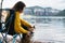 Tourist traveler girl relax tender together friends dog on background mountain scape,  woman hugging pet rest on lake shore nature