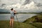 Tourist traveler photographer making pictures on background sea