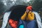 Tourist traveler ralaxing in camp tent in foggy rain forest, closeup smile hiker woman enjoy mist nature trip, green trekking