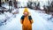 Tourist traveler woman is in the winter woods on a snowy road