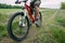 Tourist traveling riding a bike along summer field