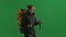 Tourist traveling using trekking poles on a hike. A man with a backpack on his back is walking on a green screen close