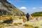 A tourist traversing the mountain trail in the fall season of the year