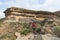 Tourist trekking on marked trail in the Golden Gate Highlands National Park, South Africa. Scenic table mountains, canyons and cli