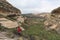 Tourist trekking on marked trail in the Golden Gate Highlands National Park, South Africa. Scenic table mountains, canyons and cli