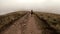 Tourist trekking mountains covered with clouds