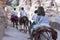 Tourist using a Bedouin donkey for transport in Petra Jordan. Descends stairs next to other tourists walking