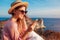 Tourist using smartphone on Aegean sea background on Santorini island, Greece. Woman traveling. Summer vacation