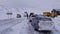 Tourist vehicles at the beginning of the road to famous North Cape (Nordkapp) waiting for the start of the convoy.