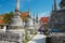 Tourist visit ancient stupas at Wat Phra Mahathat Woramahawihan temple in Nakhon Sri Thammarat, Thailand.