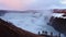 Tourist visit stand on viewpoint Gullfoss waterfall in Iceland, Cinematic beautiful majestic winter waterfall cover by snow and