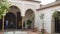 Tourist visits in a nasrid courtyard in the Alcazaba, Malaga, Spain