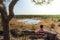 Tourist waits for wildlife at the Moringa waterhole near Halali, Etosha, Namibia