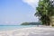 Tourist walk see the panorama of white sand beach with coconut palms taken on haad Klong Chao on tropical koh Kood island in Trat