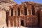 Tourist walking around beautiful Roman architecture of the Ad Deir one of the most iconic monuments in the Petra Archaeological