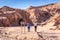 Tourist walking into Atacama`s Caverna de Sal salt cave attraction in Chile