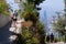 Tourist walking away from the viewer at at San CristÃ³bal Hill, Santiago.  The skyscrapers of Santiago is visible in the