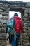 Tourist walking with backpack inside corridors of Machu Pichuu