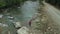 Tourist walking rocky river drone view at cloudy cold day having fun mountains