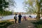 Tourist walking on the Strelecky Island with weir on Vltava river