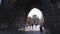 Tourist walking thru iconic Charles Bridge gates