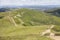 Tourist walks along mountain roads along green peaks