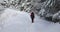 A tourist walks in winter forest