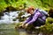 Tourist washing hands in a river