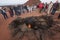 Tourist watching fire demonstration in Timanfaya volcanic national park in Lanzarote, Canary islands, Spain.