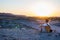 Tourist watching the stunning view of barren valley and mountains in the Namib desert, among the most important travel destination