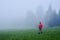 Tourist in waterproof jacket in fog