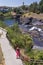 Tourist wearing pink enjoies beautiful veiw at Spoken river shores