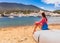 Tourist woman in Cadaques, Catalonia, Spain near of Barcelona. Scenic old town with nice beach and clear blue water in bay. Famous