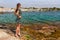 Tourist woman in Cadaques, Catalonia, Spain near of Barcelona. Scenic old town with nice beach and clear blue water in bay. Famous