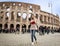 Tourist woman at colosseum monument in Rome