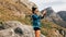 Tourist woman doing nature photography on a smartphone. Female hiker shoots video for social media