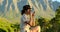 tourist woman drinks a drink from a cup and enjoys the scenery in the mountains