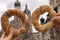 Tourist woman eating bagel obwarzanek traditional polish cuisine snack waling on Market square St. Mary& x27;s Basilica