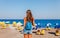 Tourist woman on Elle beach on Rhodes island, Dodecanese, Greece. Panorama with nice sand beach and clear blue water. Famous