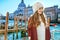 Tourist woman on embankment in Venice looking into distance