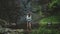 Tourist woman enjoy jungle waterfall landscape