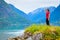 Tourist woman enjoying fjord view in Norway