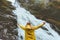 Tourist woman enjoying waterfall emotional raised hands