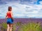 Tourist woman enjoys view of lavender fields, Provence France